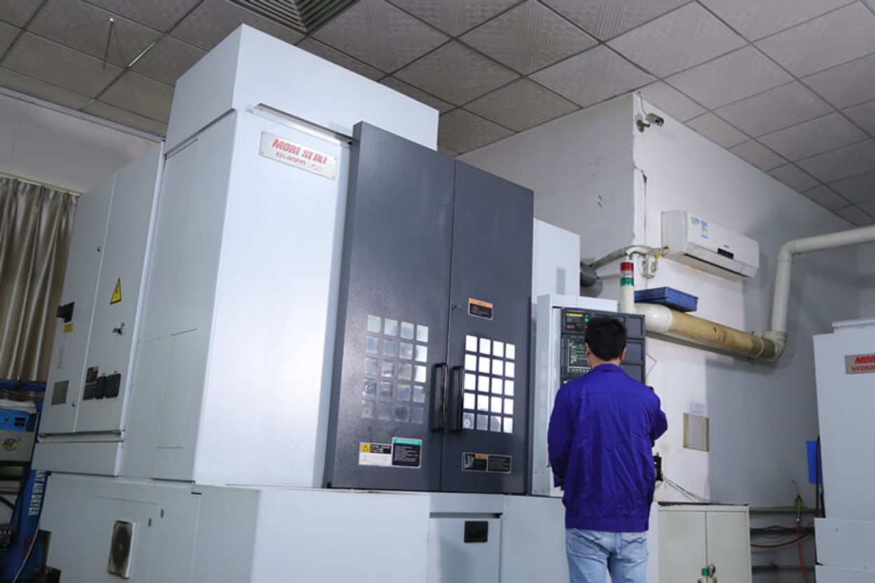 Machinist running a CNC machining center in the tool room